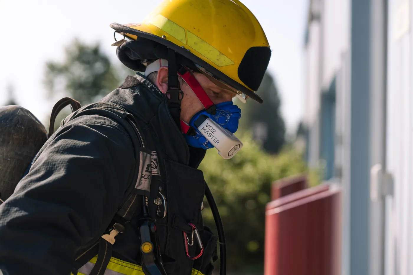 Firefighter in full kit and breathing apparatus wearing the VO2 Master analyser during a field test